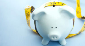 Piggy bank with tape measure wrapped around