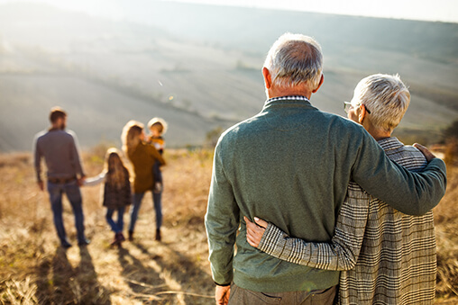 Older aged couple watching over family