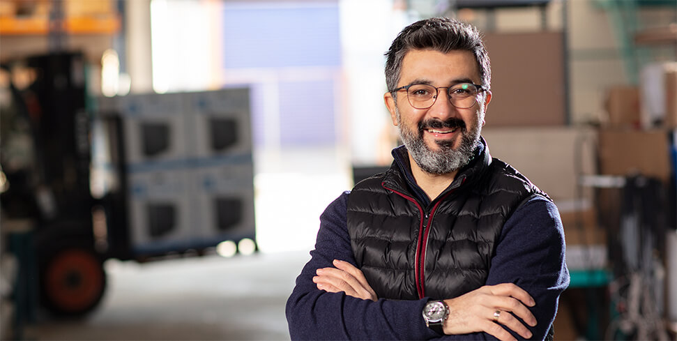 Man standing in warehouse with arms crossed